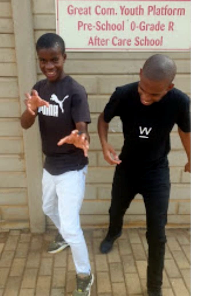 Two young people dancing outside the after-care venue