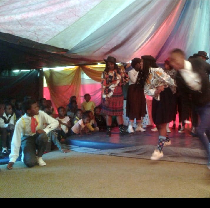 Young people performing on a small stage
